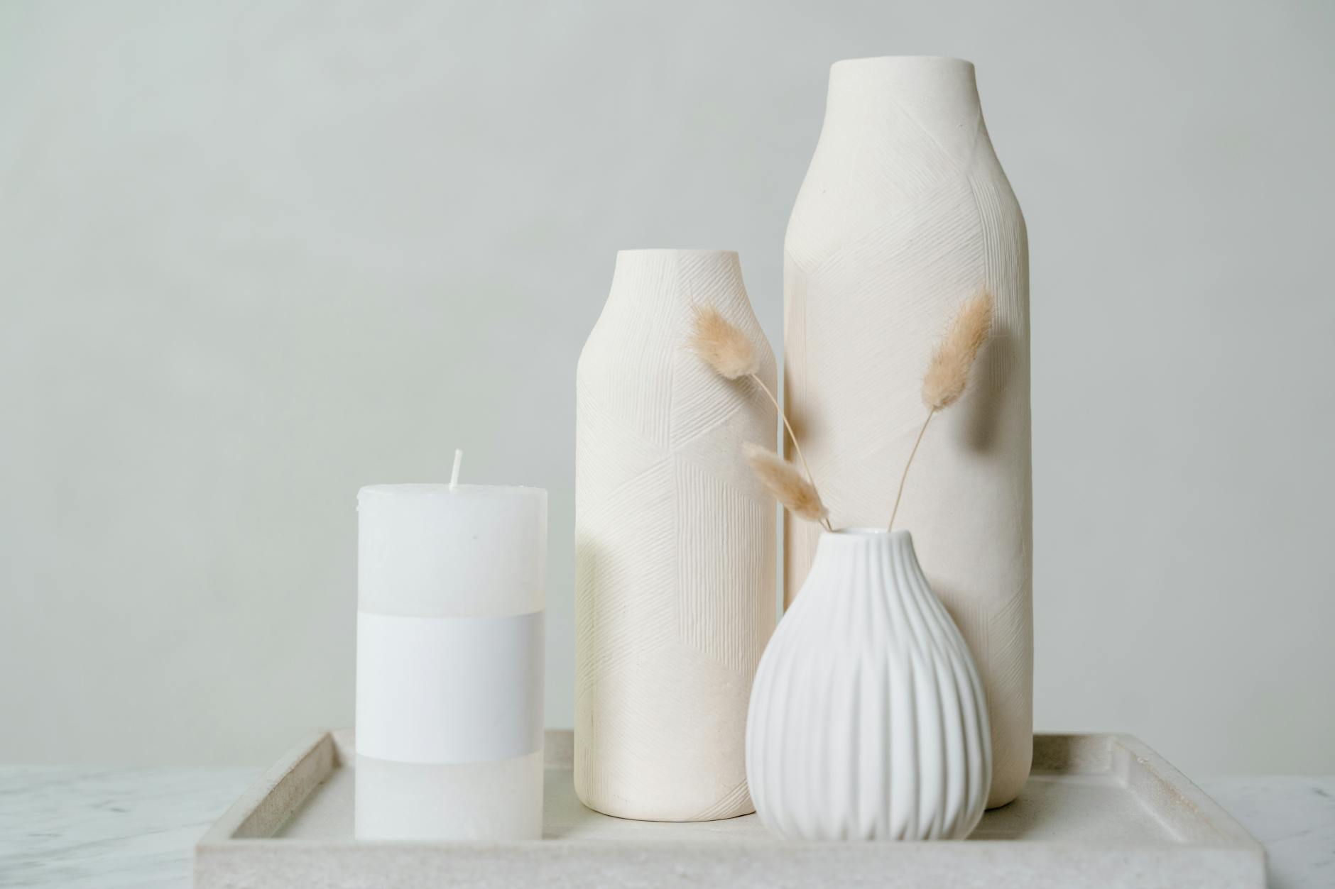 white ceramic vase on the tray